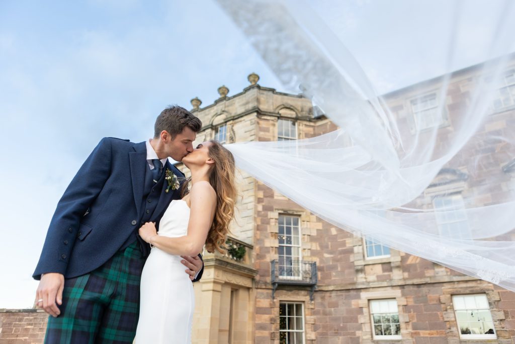 East Lothian Wedding Photographer Bride and groom kissing at Archerfield House with veil blowing captured by East Lothian Wedding Photographer Ryan White Photography
